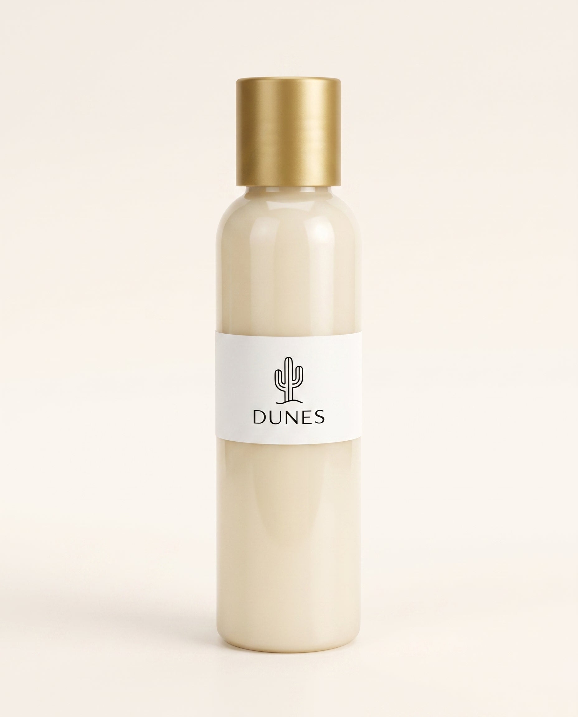 Acondicionador mini marca DUNES de 120 ml. Frasco color crema con tapa dorada y etiqueta blanca con el logo de un cactus, fotografiado sobre un fondo minimalista.